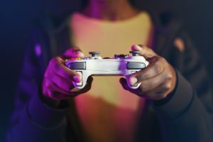 Hand playing video game using a game console entertainment technology